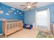 bedroom with blue walls, airplane decor, and crib at 29540 Ox Eye Ct, Wesley Chapel, FL 33543