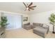 Spacious living room with grey sectional sofa and access to back patio at 29540 Ox Eye Ct, Wesley Chapel, FL 33543