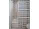 Bathroom featuring a shower/tub combo, gray tile, and a striped shower curtain at 3042 Wentworth Way, Tarpon Springs, FL 34688