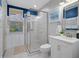 Modern bathroom with a walk-in shower and white vanity at 3042 Wentworth Way, Tarpon Springs, FL 34688