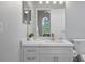 Modern bathroom with white cabinets, quartz countertop, and gold fixtures at 3042 Wentworth Way, Tarpon Springs, FL 34688