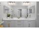 Double vanity bathroom with white cabinets, quartz countertops, and gold hardware at 3042 Wentworth Way, Tarpon Springs, FL 34688