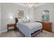 Bright bedroom with wood flooring, a queen bed, and ample natural light at 3042 Wentworth Way, Tarpon Springs, FL 34688