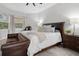 Cozy bedroom with leather bench and a king-size bed at 3042 Wentworth Way, Tarpon Springs, FL 34688