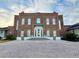 Wentworth Golf Club clubhouse with brick facade, white trim, and a paved parking lot at 3042 Wentworth Way, Tarpon Springs, FL 34688