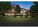 Two-story house with a landscaped lawn and a welcoming front porch at 3042 Wentworth Way, Tarpon Springs, FL 34688