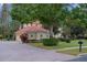 House with red tile roof and manicured landscaping at 3042 Wentworth Way, Tarpon Springs, FL 34688