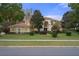 Two-story house with columns, landscaping and brick driveway at 3042 Wentworth Way, Tarpon Springs, FL 34688