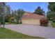 Three-car garage with brick paver driveway and basketball court at 3042 Wentworth Way, Tarpon Springs, FL 34688