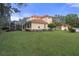 Two-story house with a manicured lawn and lush landscaping at 3042 Wentworth Way, Tarpon Springs, FL 34688