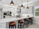 Large kitchen with island, seating, and stainless steel appliances at 3042 Wentworth Way, Tarpon Springs, FL 34688