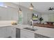 Modern kitchen with white cabinets, quartz countertops, and stainless steel appliances at 3042 Wentworth Way, Tarpon Springs, FL 34688