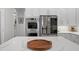 Modern kitchen with island, stainless steel appliances, and white cabinetry at 3042 Wentworth Way, Tarpon Springs, FL 34688