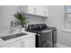 Modern laundry room with white cabinets and LG washer/dryer set at 3042 Wentworth Way, Tarpon Springs, FL 34688