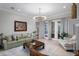 Spacious living room featuring a green sofa and access to a patio at 3042 Wentworth Way, Tarpon Springs, FL 34688