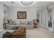 Bright living room with a large sofa and a statement piece of art at 3042 Wentworth Way, Tarpon Springs, FL 34688