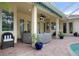 Covered patio with circular seating and pool view at 3042 Wentworth Way, Tarpon Springs, FL 34688