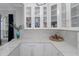 Modern wet bar with white cabinets and quartz countertop at 3042 Wentworth Way, Tarpon Springs, FL 34688