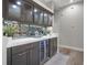 Stylish wet bar with dark cabinetry, hexagon mirror, and wine cooler at 3042 Wentworth Way, Tarpon Springs, FL 34688