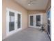 Screened porch with double doors and small table at 306 Royal Palm Way, Spring Hill, FL 34608