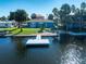 Aerial view of waterfront home with private dock and lush landscaping at 3291 Minnow Creek Dr, Hernando Beach, FL 34607