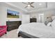 King-size bed, dresser, and large TV in this bright main bedroom at 3337 Heart Pine Ave, Odessa, FL 33556