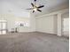 Open living room with carpet, high ceilings, and kitchen island view at 4327 Canongate Ct, Spring Hill, FL 34609