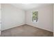 Spacious bedroom featuring a large window and carpeted floor at 4620 Tri Par Dr, Sarasota, FL 34234