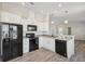 Modern kitchen featuring white cabinets, black appliances, and a breakfast bar at 4620 Tri Par Dr, Sarasota, FL 34234