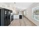 Modern kitchen with white cabinets, black appliances, and open layout at 4620 Tri Par Dr, Sarasota, FL 34234