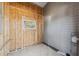Unfinished utility room with wood paneling and window at 4620 Tri Par Dr, Sarasota, FL 34234