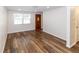 Spacious living area with wood-look vinyl flooring and neutral wall colors at 6303 Illinois Ave, New Port Richey, FL 34653