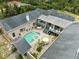 Aerial view of a home showcasing a large pool, patio, and well-maintained landscaping at 7941 Sycamore Dr, New Port Richey, FL 34654