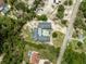 Aerial view of property featuring large home with central pool and surrounding tree coverage at 7941 Sycamore Dr, New Port Richey, FL 34654