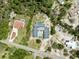 Drone shot of a house with a pool. Green trees surround the perimeter at 7941 Sycamore Dr, New Port Richey, FL 34654