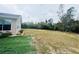 View of a large backyard with a mostly flat, grassy area at 7941 Sycamore Dr, New Port Richey, FL 34654