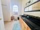 Well-lit bathroom features a framed mirror and black counter at 7941 Sycamore Dr, New Port Richey, FL 34654