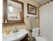 Functional bathroom with a vanity, mirror, and tiled walls, providing a clean and practical space at 7941 Sycamore Dr, New Port Richey, FL 34654