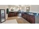 Luxurious bathroom featuring dual vanities, framed mirrors, custom dark wood cabinets and tile flooring at 7941 Sycamore Dr, New Port Richey, FL 34654