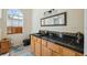 Bathroom features modern lighting, a long mirror, and updated vanity at 7941 Sycamore Dr, New Port Richey, FL 34654
