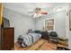 Simple bedroom with a single bed, chair, and a chest of drawers, creating a cozy space at 7941 Sycamore Dr, New Port Richey, FL 34654