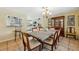 Spacious dining room includes a large table and an antique china cabinet at 7941 Sycamore Dr, New Port Richey, FL 34654