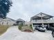 Well-maintained exterior elevation showcases a spacious home with a circular driveway and lush landscaping at 7941 Sycamore Dr, New Port Richey, FL 34654
