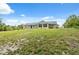 Exterior shot of home with large yard and multiple windows at 7941 Sycamore Dr, New Port Richey, FL 34654