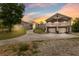 Two-story home with a two-car garage, balconies, and a long driveway at dusk at 7941 Sycamore Dr, New Port Richey, FL 34654