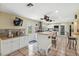 Bright kitchen featuring white cabinets, kitchen island, and tile flooring at 7941 Sycamore Dr, New Port Richey, FL 34654
