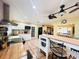 Bright kitchen with island, white cabinets, butcher block countertops, and stainless steel appliances at 7941 Sycamore Dr, New Port Richey, FL 34654