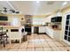 Updated kitchen featuring an island, white cabinets, and a tile backsplash at 7941 Sycamore Dr, New Port Richey, FL 34654