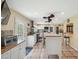 Kitchen with modern appliances, an island with seating, and tile floors at 7941 Sycamore Dr, New Port Richey, FL 34654