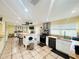 Spacious kitchen with island, white cabinets, and stainless steel appliances at 7941 Sycamore Dr, New Port Richey, FL 34654